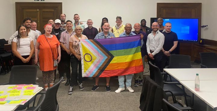 LGBTQ+ campaigners and Lambeth Councillors and Officials holding the Progress flag