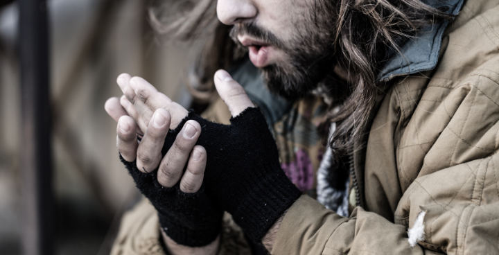 Man blowing on hands