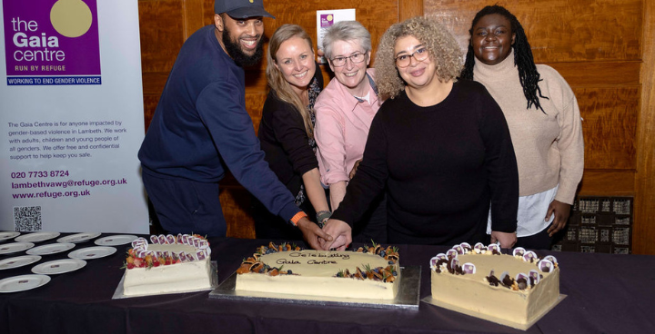 Council staff and partners at Gaia Centre event cutting cake