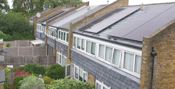 Row of 2-storey houses with solar panels.