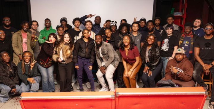 Large group of young people huddle for a photo during the Next Us programme