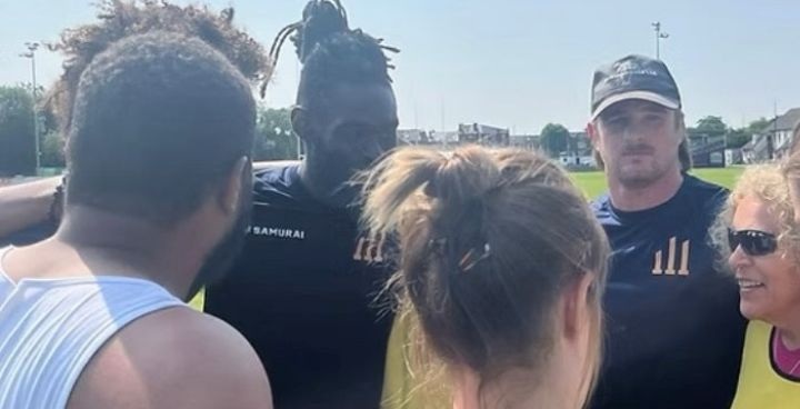 3 pillars sports coaching staff linking arms in a circle