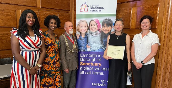 Cl;lrs Manley-Browne, Garden, Adem & Holland with Baytree Centre holding plaque on art exhibition in Town Hall