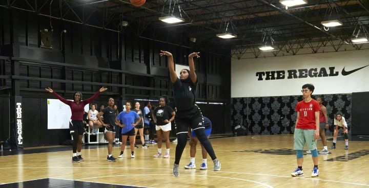 London basketball association - young woman in black & hijab scores at the Regal court