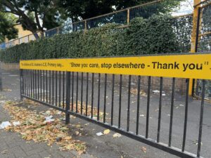 A sign encouraging drivers not to stop outside a school