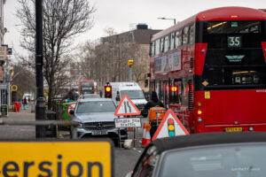 A bus waits at temporary road work traffic lights on Acre Lane