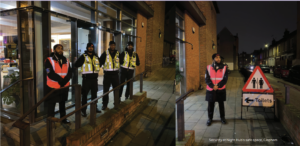 Members of the night hub team, stood in high-vis security outfits in Clapham