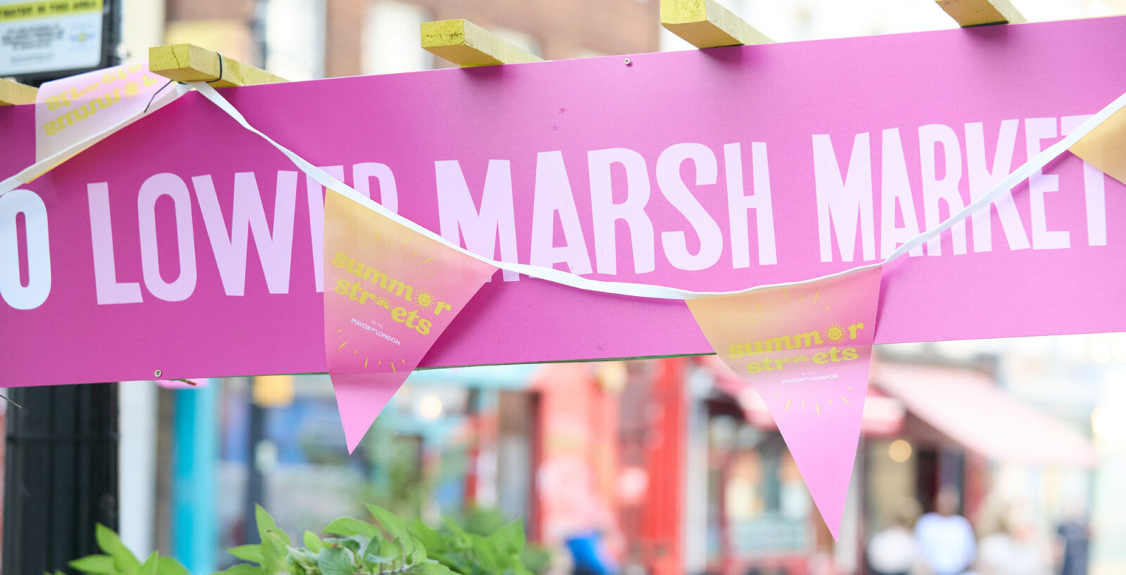 Pink street banner that says Lower Marsh Market with Summer Streets fanfare
